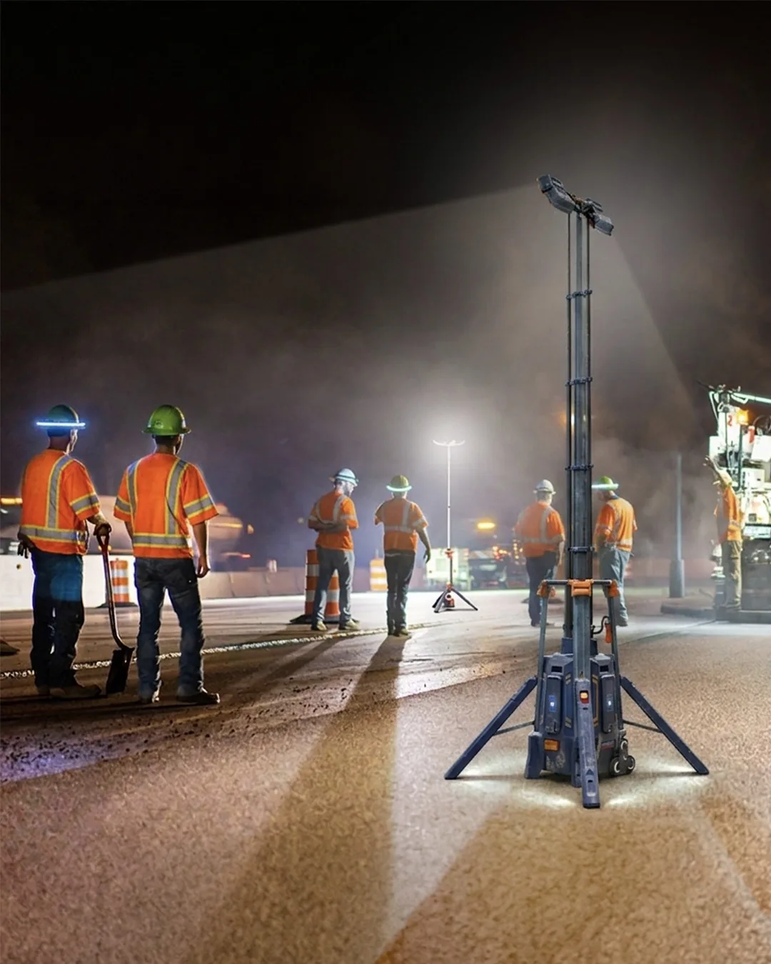 Road crew working at night under a G-COMIN light tower