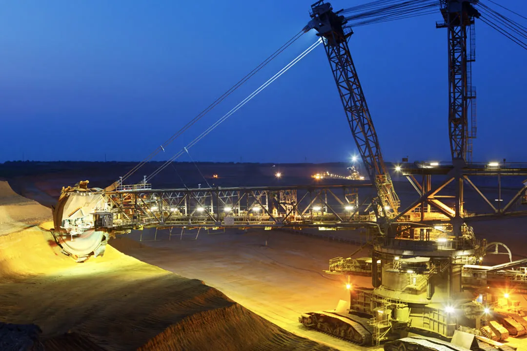 Open-pit mining operation lit at dusk