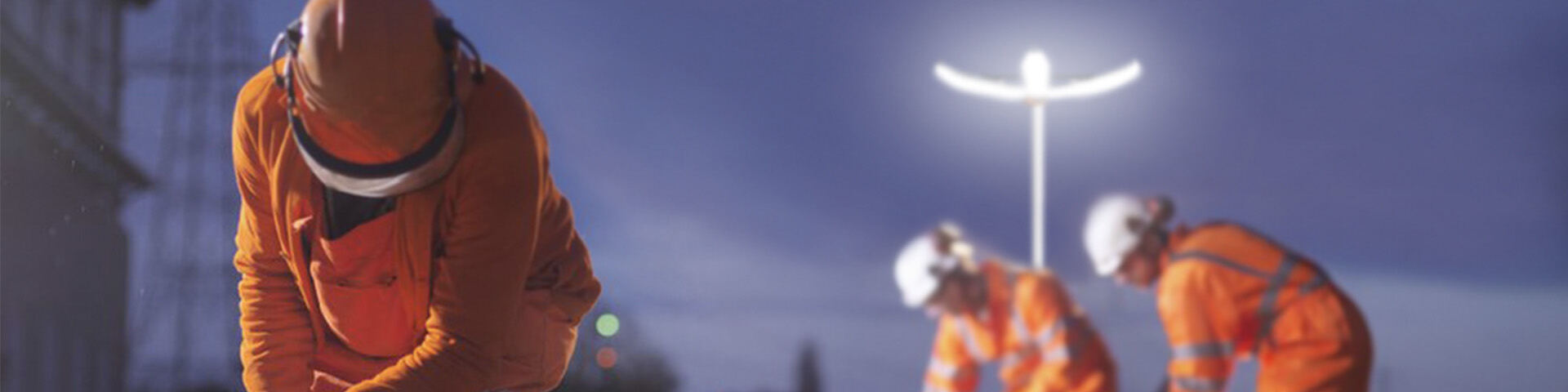 Crew working at night next to a PL-200 tower with its petal light head open
